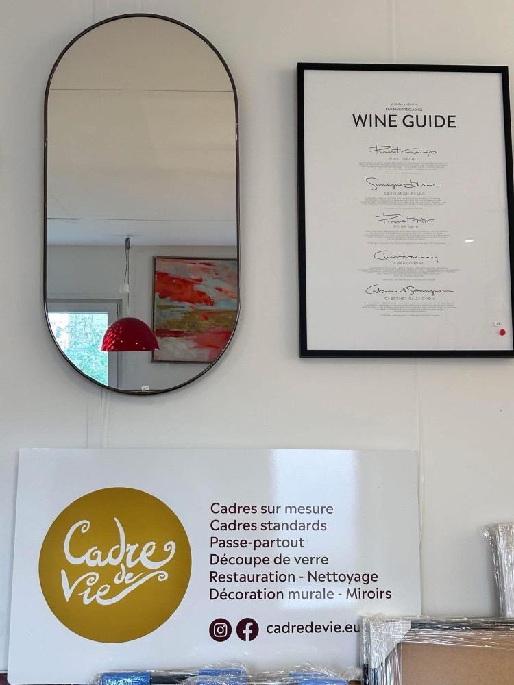 Miroir et affiche encadrée au-dessus du panneau des services de Cadre de Vie